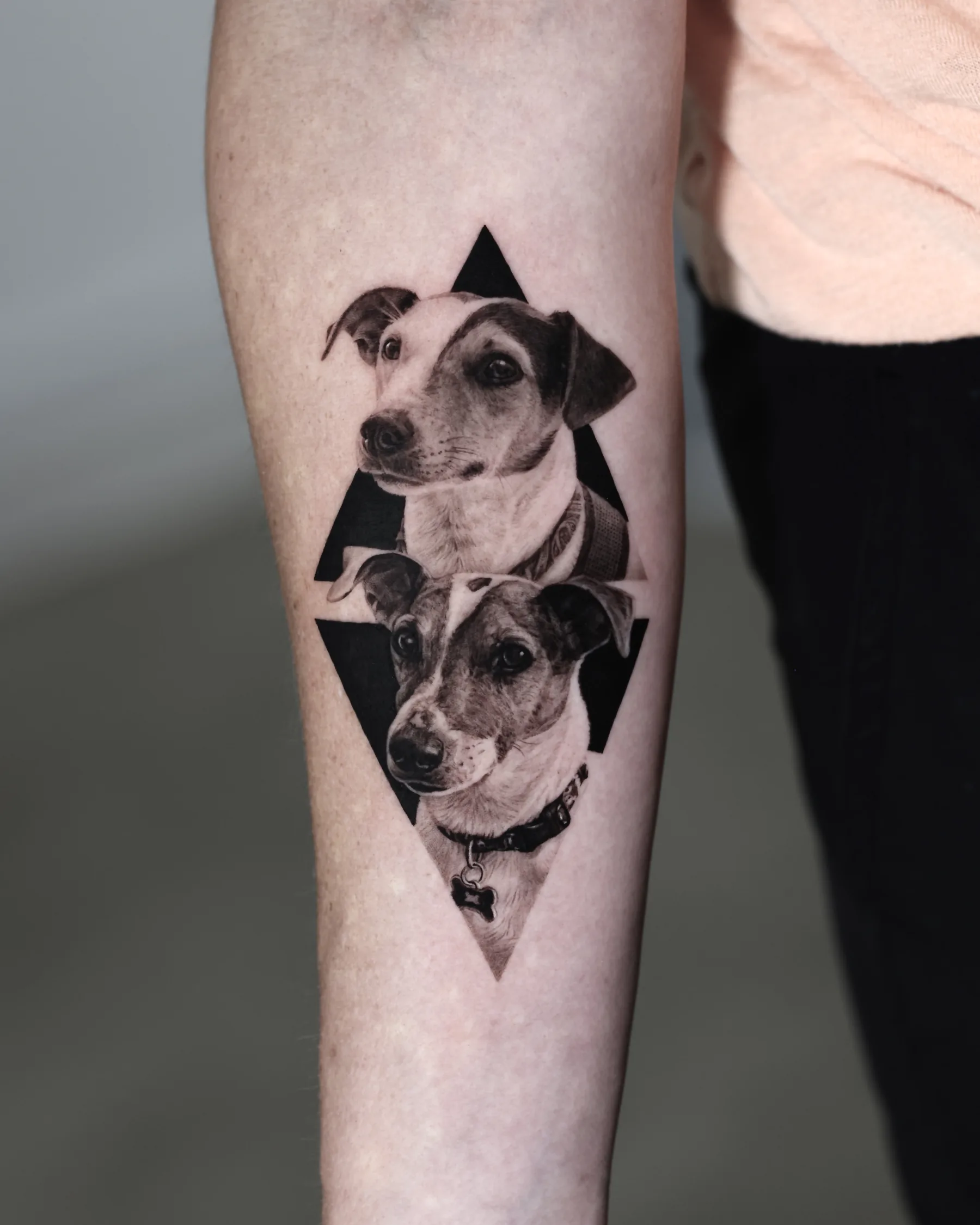 Black and grey portrait tattoo of two dogs